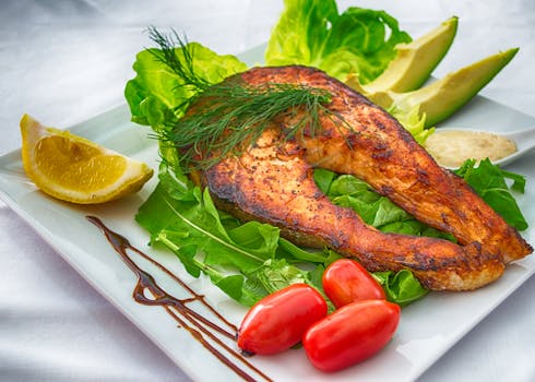 salmon, leafy greens, and berries on a plate