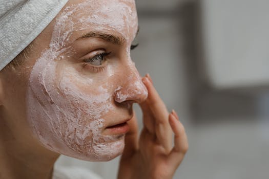 a woman applying a natural face mask