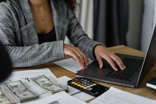 woman reviewing her budget with a calculator