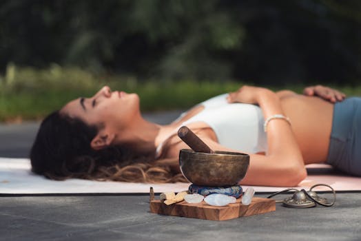 a woman practicing yoga outdoors with a peaceful look