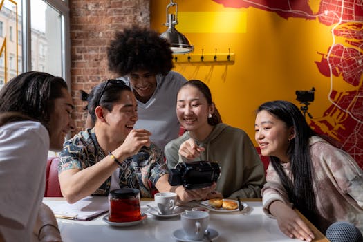 a woman smiling while enjoying a cup of tea